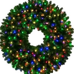 a christmas wreath with multicolored lights on the front and side of it, against a white background