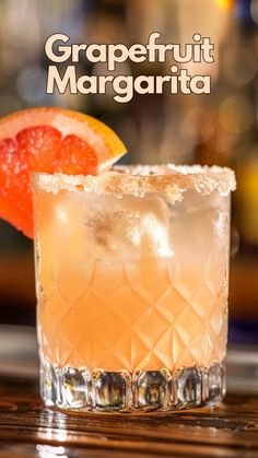 the grapefruit margarita is garnished with an orange slice