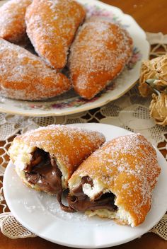 two plates with pastries on them sitting on a table