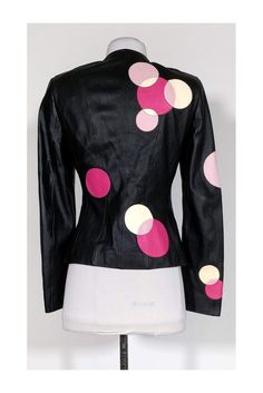 Make a statement with this black leather jacket. It features white and pink circles that give it a unique and fun look. Make this your new layering piece for the springtime! Size US 4 - DE 34 100% leather Silk lining w/ circle print Rounded neckline Zipper front Padded shoulders Cream & pink leather circle design Bust 32" Waist 29" Shoulder to hem 22" Spring Leather Jacket With Contrast Stitching, Leather Outerwear With Contrast Collar, Pink And Black Leather Jacket, Fitted Black Embellished Leather Jacket, Fitted Pink Leather Outerwear, Circle Print, Rounded Neckline, Black Leather Jacket, Circle Design