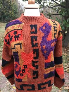 "Vintage 80's Abstract Design Sweater has rust background with pops of color with purple, orange,black and gold. Tunic length sweater has ribbed knit at the round neckline,cuffs and bottom. Sweater in excellent vintage condition and made by \"Le Pull-Over\" by Irene Leung. Size label states a US ladies small. Please check measurements below for a proper fit. Excellent Vintage Condition Materials : 55% Ramie 45% Acrylic Hand Wash Cold Measurements taken flat-double where necessary. Shoulder to sh Retro Brown Sweater For Fall, Vintage Multicolor Sweater For Fall, Vintage Orange Sweater For Fall, Retro Brown Knitted Sweater, Retro Brown Crew Neck Sweater, Multicolor Vintage Sweater With Graphic Print, Handmade Vintage Multicolor Sweater, Vintage Multicolor Graphic Print Sweater, 80s Print Sweater