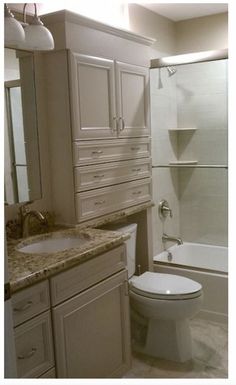 a bathroom with a sink, toilet and bathtub next to a walk in shower