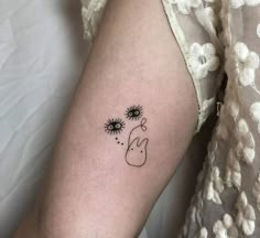 a woman's arm with sunflowers on it