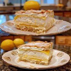 two slices of lemon meringue pie sitting on top of a plate next to each other