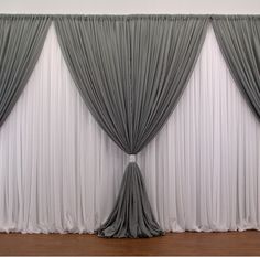 the curtains are lined up against the wall and ready to be used as a backdrop