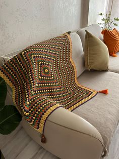 a crocheted blanket on the back of a couch