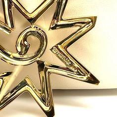 Paloma Picasso, for Tiffany & Co. geometric star motif pin brooch in 18k solid yellow gold.   Stamped: '750' - 'Paloma Picasso' - 'Tiffany & Co.'   ✔ Metal: 18K Yellow Gold ✔ Weight: 11.8g ✔ Measurements: 42mm x 38mm  Condition: Minor cosmetic marks on the front and back that can be polished off to look brand new. Pin, stamps, and signature in excellent condition.   ★ Ships from Miami Florida ★ Gold Star Brooches As Gift, Formal Star-shaped Brooch Jewelry, Paloma Picasso, Geometric Star, Gold Brooches, Pearl Brooch, Paloma, Matte Gold, Tiffany & Co.