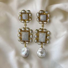 Elevate your bridal ensemble with these stunning handmade moonstone and baroque pearl statement earrings, perfect for weddings and special occasions. These exquisite earrings are designed to make you shine on your special day. Each earring features a genuine square-cut moonstone (approximately 13mm x 13mm) surrounded by delicate, genuine tiny rice pearls. The moonstone's iridescent glow is captivating, making it a standout piece. The connector of the earrings is equally breathtaking, with a rect Luxury Mother Of Pearl Earrings For Wedding, Elegant Wedding Moonstone Earrings, Luxury Mother Of Pearl Wedding Earrings, Handmade Moonstone Wedding Earrings, Handmade Moonstone Earrings For Wedding, Luxury Baroque Pearl Earrings For Wedding, Luxury Baroque Wedding Earrings, Luxury Gemstone Pearl Earrings For Wedding, Luxury Pearl Gemstone Earrings For Wedding