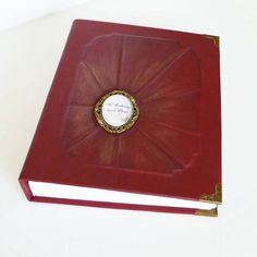 a red book sitting on top of a white table