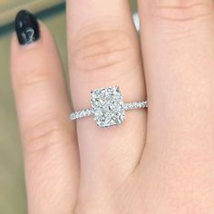 a woman's hand with a ring on it and a diamond in the middle