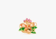 a gold ring with pink flowers and green leaves on the front, against a white background