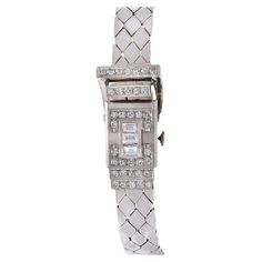 Introducing a masterpiece from Pesag, Vintage Retro Era design, the 14KT White Gold and Diamond Hinge Case Ladies Wrist Watch. This exquisite timepiece, featuring a 17x37mm case, exudes sophistication and glamour with its captivating design. Encased in 14KT White Gold, the hinge case is adorned with sparkling Diamonds totaling 2.75CT-TW, featuring a mix of F-VS-SI Emerald and Single Cut Rounds. The total weight of the watch is 48 grams. The Silver Dial, complemented by Roman Numeral markers, add Cocktail Watch, Ladies Wrist Watch, Retro Era, Bracelets Gold Diamond, White Gold Bracelet, Roman Numeral, Women Wrist Watch, Roman Numerals, Sparkle Diamonds