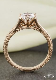 an antique style engagement ring with a diamond in the center