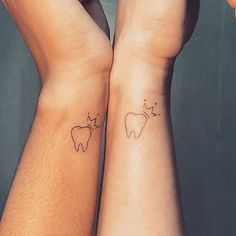 two people with matching tattoos on their arms