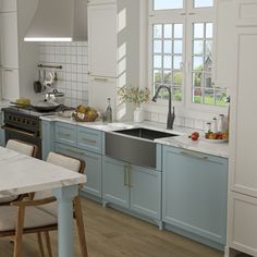 a kitchen with blue cabinets and white counter tops