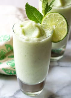 two glasses filled with ice cream and lime slices