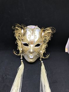 Venetian Mask for decoration - Traditional and original papier-mache Venetian mask, handmade and decorated with metal insert, gold-leaf and glitters,enriched with Swarovski crystals. Dimension::Hight 31cm,width 24cm Decoration only,not wereable All our masks are handmade papier-machè masks made in Venice. Our decorators use techniques typical of the Venetian tradition such as stucco, acrylics, gold and silver-leaf, macramè, passementerie, glitters and crequelè to offer you a wide range of origin Gold Formal Masks For Carnival, Gold Venetian Masquerade Mask For Formal Occasions, Gold Masks For Formal Carnival Occasions, Gold Masks For Carnival And Formal Events, Gold Fantasy Mask For Costume Party, Gold Fantasy Style Masquerade Mask For Party, Gold Fantasy Masquerade Mask For Party, Gold Full Face Masquerade Mask For Carnival, Formal Gold Eye Mask