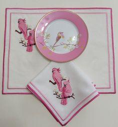 two pink and white napkins with birds on them