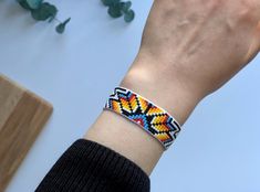 a person wearing a colorful bracelet on their wrist