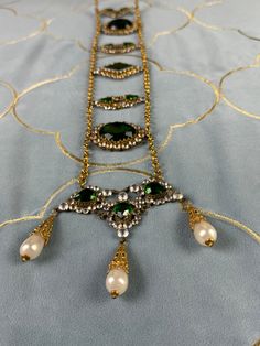 Wow! This exquisite antique belt made of rhinestones, green stones and glass pearls comes from a German collection of theatrical jewelry. Very artistically crafted. And older than you might think. It probably dates from the period between 1890-1910. Actresses wore it on stage in exotic roles (like Salome).  In very good to excellent condition. Original condition. Nothing altered.  Very, very rare to find. Even rarer are these pieces offered for sale. Most are in private collections. Traditional Embellished Gold Necklace, Traditional Gold Embellished Necklace, Victorian Jeweled Evening Jewelry, Traditional Embellished Formal Jewelry, Elegant Green Beaded Choker, Antique Green Jewelry For Evening, Traditional Embellished Wedding Necklaces, Gold Embellished Jewelry For Formal Occasions, Antique Jeweled Necklaces For Party