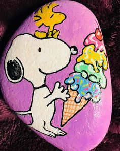 a painted rock with a cartoon character holding an ice cream cone