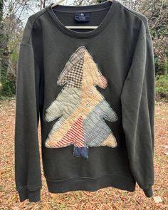 a sweater with a dog on it hanging from a clothes line in the woods,