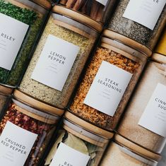 several jars filled with different types of spices and seasonings on top of each other