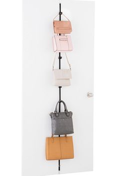 three purses are hanging on the wall