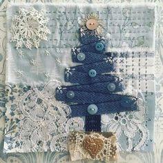 a blue christmas tree with buttons and lace