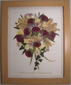 an image of a bouquet of flowers in a wooden frame