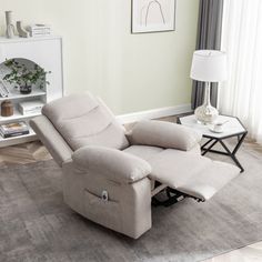 a recliner chair sitting on top of a rug in a living room