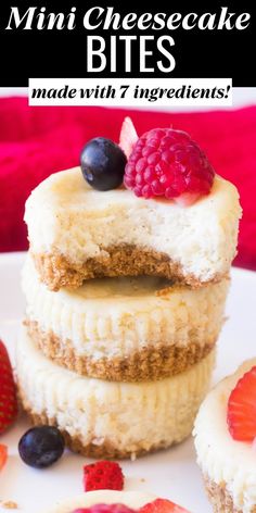 three mini cheesecake bites are stacked on top of each other with berries and blueberries