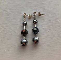 "*Handmade item *Materials: round silver hematites, round dark multicoloured rondelles, tiny silver-plated beads, silver-plated studs with butterfly backs, beaded on earring pins  *Earring length: approximately 1.5\" [4 cm] including the hooks   Includes gift box 4cm x 5cm" Silver Beaded Earrings With Polished Beads As Gift, Silver Polished Beaded Earrings As Gift, Silver Polished Beaded Earrings For Gift, Silver Earrings With Polished Beads For Gift, Silver Beaded Earrings With Faceted Beads, Silver Round Beaded Earrings With Faceted Beads, Silver Hematite Round Beads Jewelry, Silver Hematite Jewelry With Round Beads, Silver Beaded Earrings With Spacer Beads