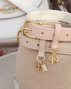 a close up of a belt with two charms attached to it's buckles