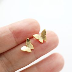 Beautiful and lovely tiny gold butterfly stud earrings. The post material is 925 silver post and the butterfly is gold-plated brass. Your earrings will ship in a gift box.    ♥ Earring size approx. 3/8" ♥Post Material  925 silver post ♥ 14K Gold Plated ♥ 1 Pair ♥ Delivery Time Fast shipping within 1 - 3 days  ♥  See more Rudiana Accessories  Rudiana.etsy.com Rose Gold Butterfly Charm Earrings As Gift, Rose Gold Butterfly Charm Earrings For Gift, Gold Minimalist Earrings With Butterfly Charm, Minimalist Gold Earrings With Butterfly Charm, Delicate Butterfly Earrings Gift, Rose Gold Earrings With Butterfly Charm As Gift, Delicate Gold Earrings With Butterfly Charm, Minimalist Butterfly Charm Earrings, Minimalist Butterfly Charm Earrings For Gift