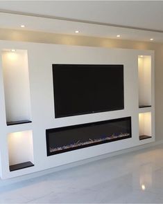 a large television mounted to the side of a wall in a living room with white walls