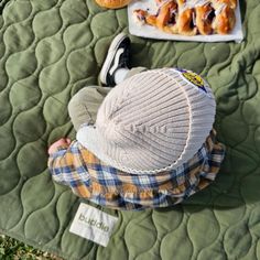 a little boy laying on top of a blanket next to doughnuts