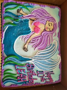 there is a birthday cake in the shape of a mermaid on it's side