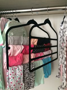 a rack with clothes hanging on it in a closet