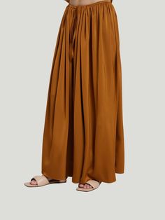 The DEPT.ANONYM Silky Wide Leg Pants are the epitome of luxury and style. These showstopping pants are one-size-fits-most, flowy wide-leg pants that can easily take you out on the town or to your next special occasion. Made from a satin-like material, these palazzo pants will have you feeling like royalty and looking like it too! The pant silhouette with a drawstring makes these pants a chic and effortless option for most body types. Additional Details: One Size Wide Leg Palazzo Pants Drawstring Silk Wide Leg Pants With Elastic Waistband, Wide Leg Silk Pants With Elastic Waistband, Silk Wide-leg Pants, Chic Flowy Wide Leg Maxi Skirt, Chic Flowy Bottoms For Fall, Silk Long Skirt For Fall, Silk Wide Leg Bottoms With Elastic Waistband, Silk Wide-leg Bottoms With Elastic Waistband, Elegant Wide Leg Harem Pants With Elastic Waistband