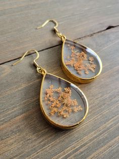 Beautiful and elegant mixed orange wildflower earrings with REAL fiery orange petals, perfectly preserved in resin for it's natural beauty. Vividly colorful flower earrings in the shape of resin teardrops, comfortablely lightweight earrings, handmade with gently dried flowers ♥ Be sure to check out the ORANGE EARRINGS section at EarringsbyLCreations for all beautiful orange colored earrings available! https://www.etsy.com/shop/EarringsByLCreations?section_id=28420987 Made with quality materials Orange Drop Earrings For Gift, Gold Teardrop Birth Flower Earrings, Handmade Orange Teardrop Earrings For Gift, Gold Teardrop Flower Earrings With Pressed Flowers, Orange Flower Earrings For Gift, Orange Dangle Flower Earrings For Gift, Hypoallergenic Gold Flower Earrings With Resin, Orange Dangle Flower Earrings Gift, Elegant Teardrop Pressed Flower Earrings