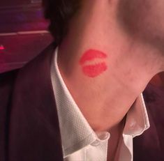 a man with red lipstick on his face