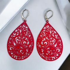 Experience the elegance and compatibility of our large stainless steel drop-shaped earrings. These impressive earrings are 7 cm long and impress with their unique ornamental design and strong color. The earrings are fitted with stainless steel ear hooks, which ensure a high level of comfort and are particularly skin-friendly. Our earrings are nickel-free and will not discolour, making them ideal for those with sensitive skin. The eye-catching design makes them the perfect accessory for special o Laser Cut Teardrop Jewelry As A Gift, Red Teardrop Chandelier Earrings As Gift, Red Nickel-free Chandelier Earrings As Gift, Nickel Free Elegant Red Chandelier Earrings, Elegant Nickel-free Red Chandelier Earrings, Red Teardrop Chandelier Earrings With Ear Wire, Red Teardrop Chandelier Earrings, Red Elegant Nickel-free Teardrop Earrings, Nickel-free Red Teardrop Earrings