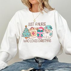 Just A Nurse Who Loves Christmas Sweatshirt, Holiday Nurse Xmas Sweatshirt Cute Trendy Shirt, Nurse Sweater Gift ER Nurse 🌸 Soft & Lightweight Material - Graphic tees for women are made from a soft, lightweight, and stretchy fabric that provides a familiar and comfortable feel. You'll love wearing it all day long. 🌸 GREAT GIFT:  Good choice as a gift for your mom, sister, your wife or anyone you want to send a gift.  🌸 Wash: Recommended machine/hand wash and wash inside out and line dry. PLEASE DON'T Put IT IN THE DRYER, DRY CLEAN, or BLEACH. ♥️Designed and Handmade in the USA♥️ Nurse Sweater, Graphic Tees For Women, Er Nurse, Shirts Ideas, Sweatshirt Cute, Sweater Gift, Gifts For Your Mom, Trendy Shirts, Tees For Women