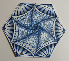 a blue and white ornament is shown in the shape of a pentagon with an intricate design on it