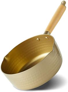 a gold pan with a wooden handle on a white background