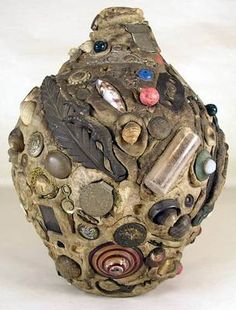 a sculpture made out of different types of buttons and other things on top of it