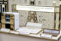 an electronic device is on display in a room with gold trimmings and white boxes