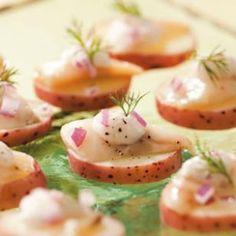 small appetizers are arranged on a green platter