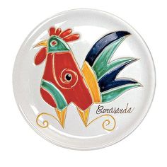 a glass plate with an image of a rooster on it's face and the words berasida written in spanish